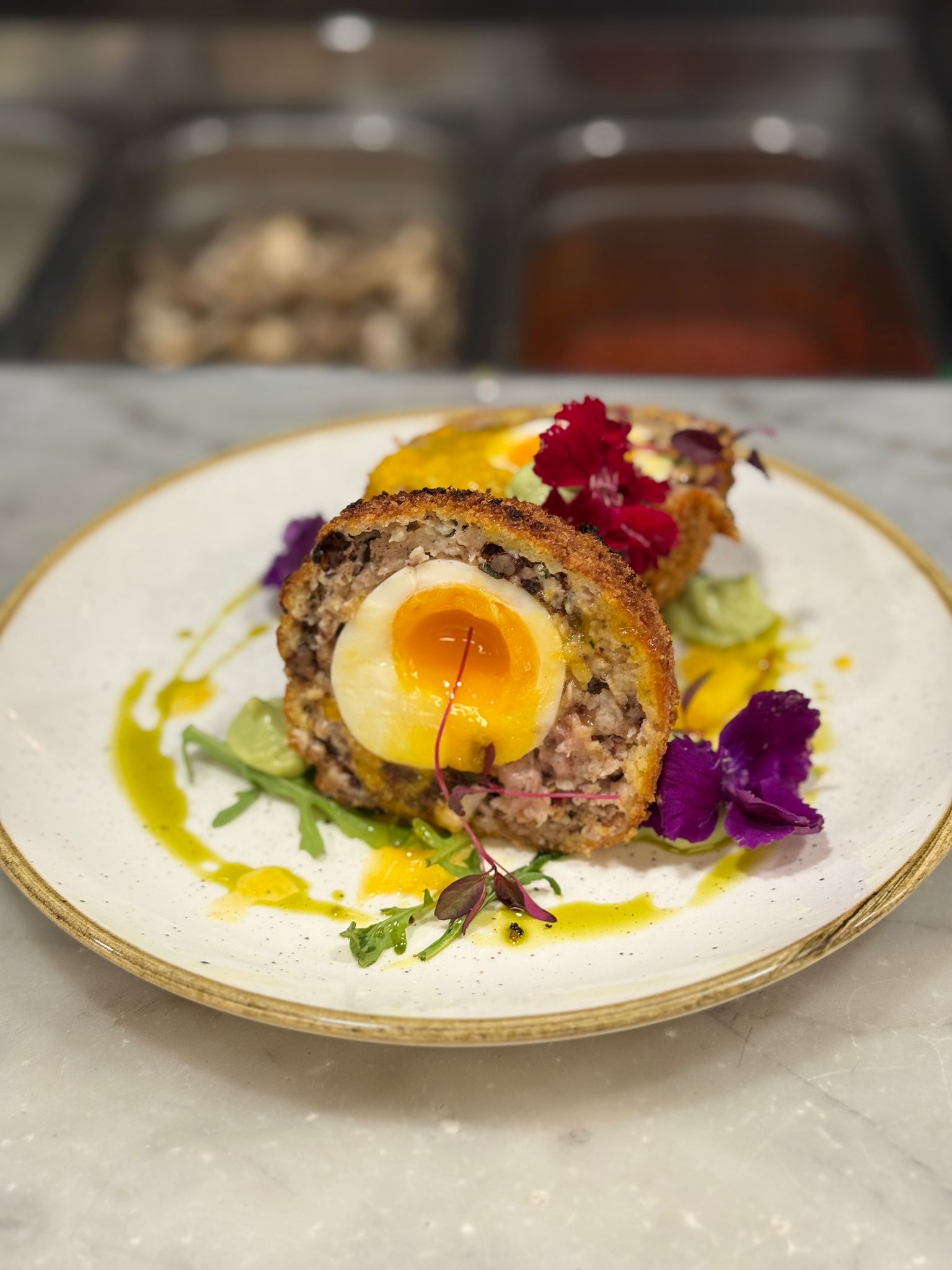 Classic scotch egg, halved, with piccalilli
