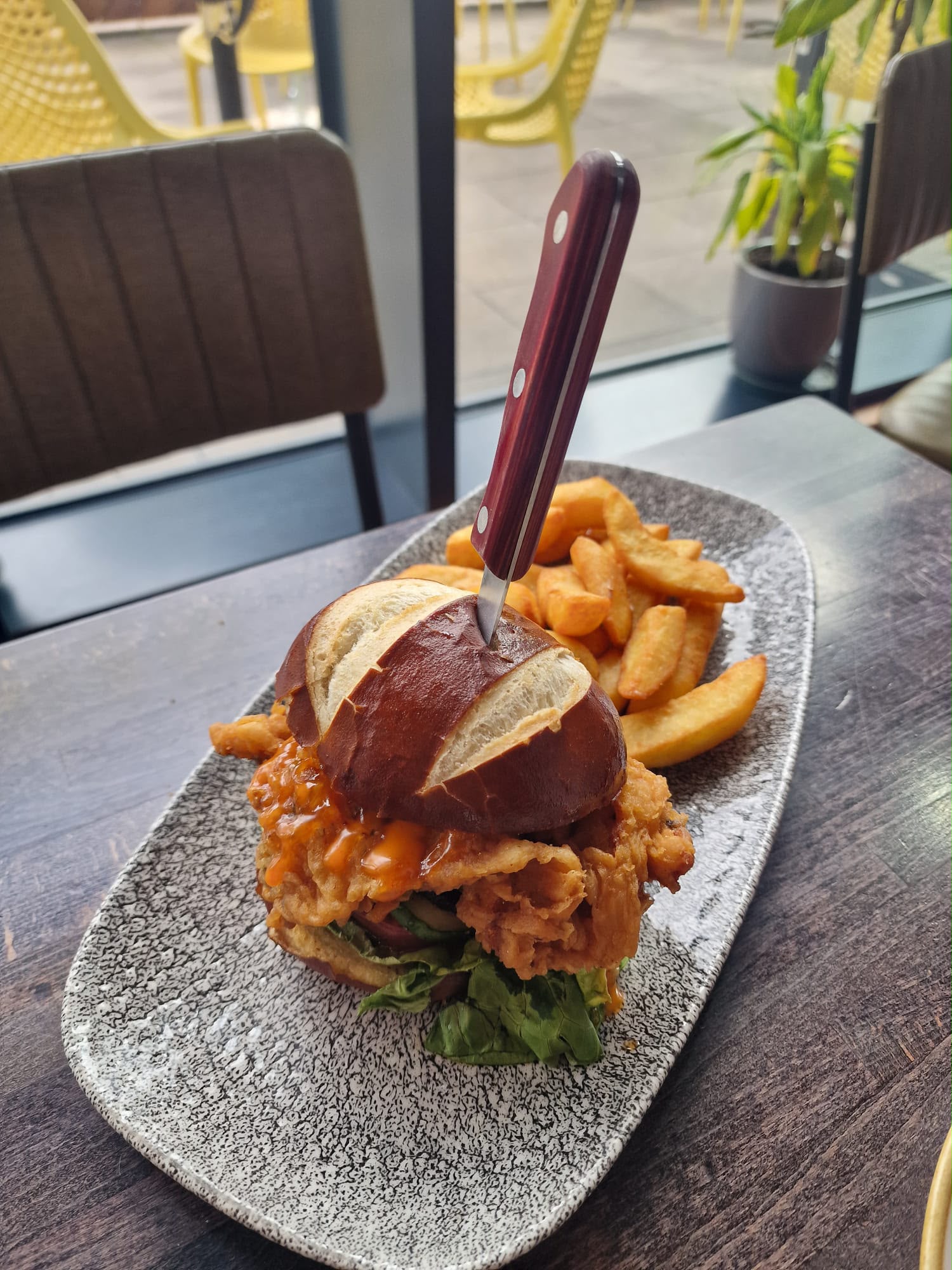 Buttermilk chicken burger on a pretzel bun with chips